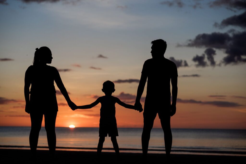 A family at sunset, holding hands