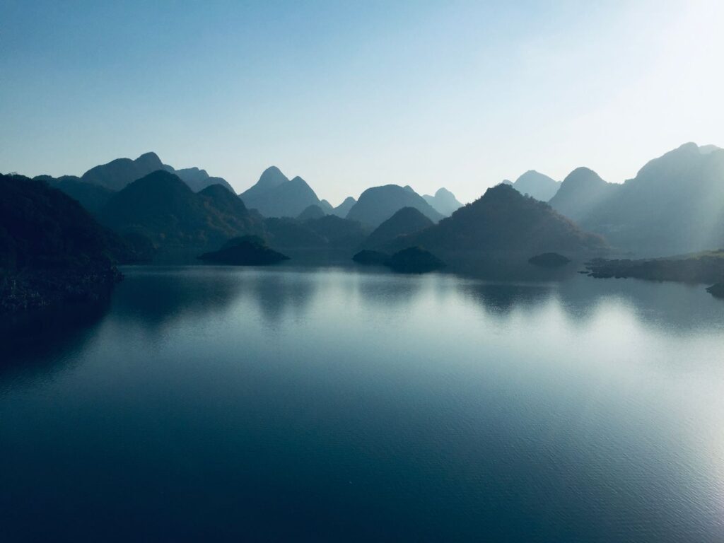 Misty mountains over a calm lake, the long view